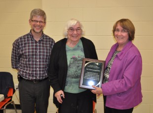 Amy Steele Kempster is awarded a plaque on October 16th 2014 by the Champlain Park Community Association for 30 years as a community volunteer with achievements in negotiations with NCC, as our contact with the Federation of Community Associations, and in keeping us updated on current issues through her column "Amy's Corner" in our neighbourhood newsletter. Way to go, Amy! Presenters are Carol Arnason and Dennis Van Staalduinen.  Photo by John Arnason.