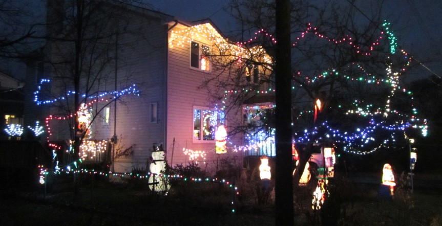 [House with strings of lights all over the place and hordes of glowing snowmen on the ground]